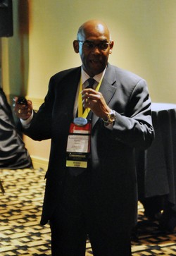 Photo of a man speaking into a microphone
